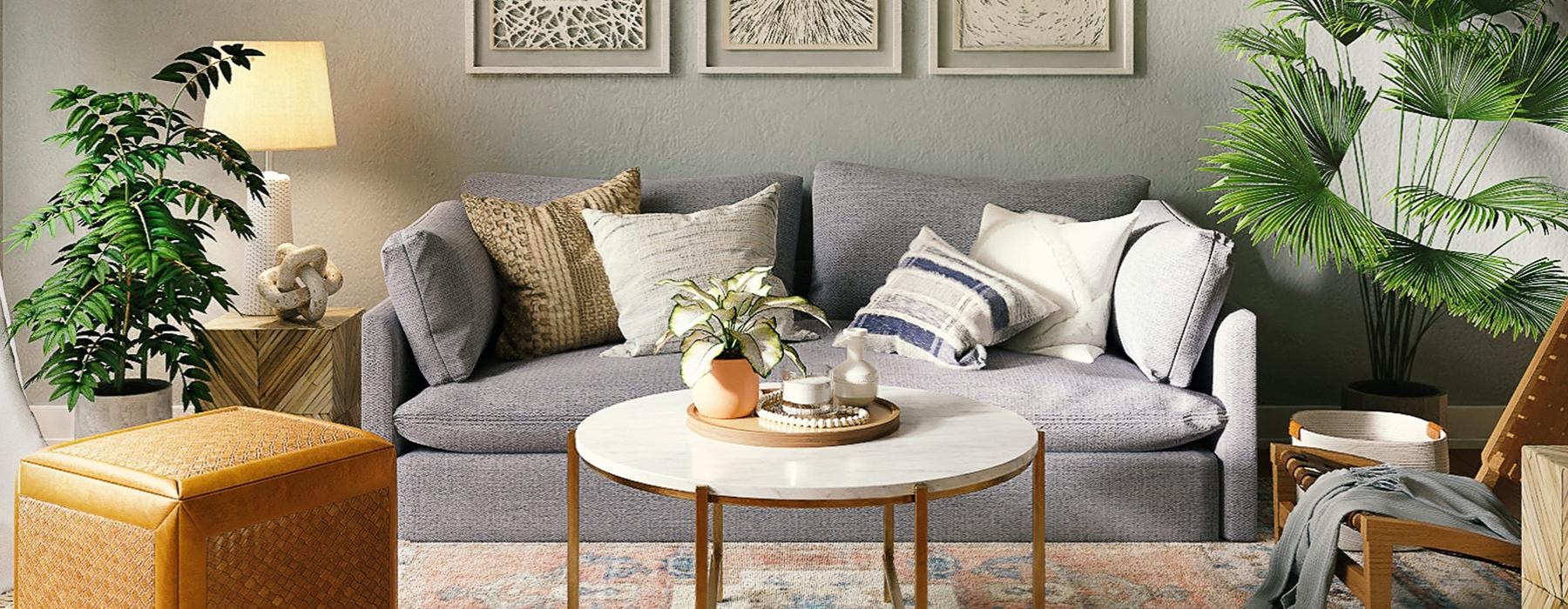 a couch with a coffee table and plants in the background