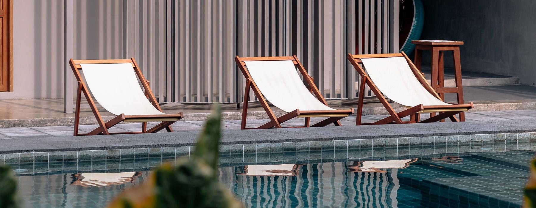 chairs next to a pool